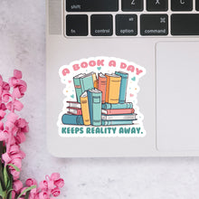 Load image into Gallery viewer, A Book A Day Keeps Reality Away Sticker

